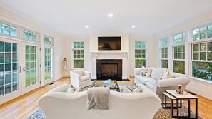 Cozy living space with a fireplace, sofas, and a coffee table.