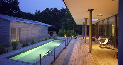 Modern home sited on a lush wood acre, stunning pool, covered deck, outdoor...