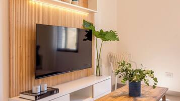 Deluxe Apartment, Courtyard View | Living area | Flat-screen TV