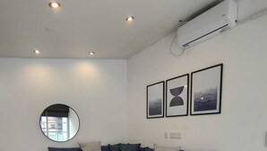 A modern living room with a sectional sofa, a round mirror, and a wooden coffee table. - UPOINT Recoleta (Buenos Aires)