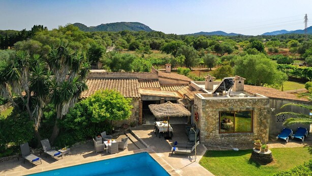A villa with a swimming pool, outdoor seating, and a view of the surrounding landscape. - H2933 Finca Tia in Pollenca (Pollenca)