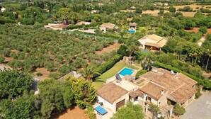 An aerial view of a residential area with houses, a swimming pool, and surrounding greenery. - H2933 Finca Tia in Pollenca (Pollenca)