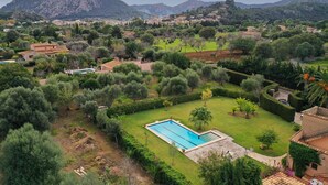 A residential area with a swimming pool surrounded by lush greenery and a mountainous backdrop. - H2935 Finca Solivelles in Pollenca for 8 persons (Pollenca)