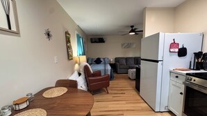 A compact living space with a dining table, kitchen area, and seating area. - Charming tiny home only 15 mins from Town of Warrenton & Town of Culpeper (Rixeyville)