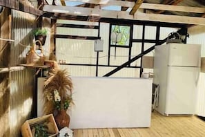 A rustic kitchen with a wooden ceiling, a white countertop, and a refrigerator. - #Y6 Wild West- 2 Double beds -Pet friendly, Wild West Yurt 2 Double Beds (Drumheller)