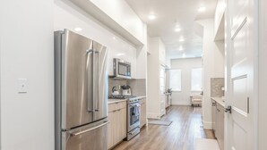 A modern kitchen with stainless steel appliances, a microwave, and a built-in oven. - Cozy, Downtown Boise, BSU, Getaway! (Boise)