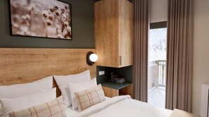 A hotel room with a wooden headboard, a large bed with white bedding, a wall-mounted light, and a view of a balcony. - Wifi, ski-in/ski-out & foot of the slopes, fitness, swimming pool, balcony, parking, tv, ski locker (Vars)