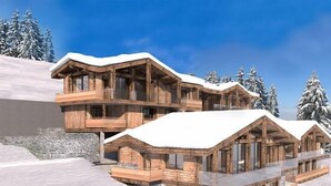 A multi-story wooden chalet with balconies, set against a snowy mountain backdrop.