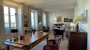 Enjoy a classic layout with a large desk and comfortable seating area, a fireplace, and city views.
