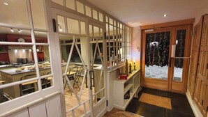 A kitchen with a view of the snowy outdoors through a glass door. - Chalet, wifi, 130m from resort center, sauna, terrace, parking, tv, ski locker, 450m², Alpe d'Huez (L'Alpe d'Huez)