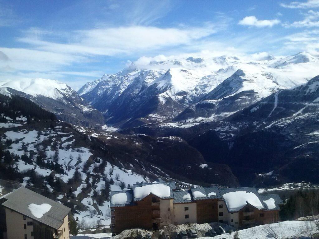 A mountain resort with snow-covered peaks and a valley.