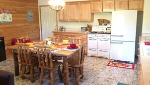 A kitchen with wooden cabinets, a stove, and a refrigerator.