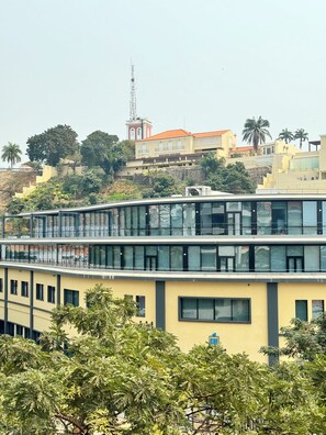 A modern building with multiple floors, large windows, and a yellow facade. - Peaceful APT-Near Luanda Bay/prime location (Luanda)