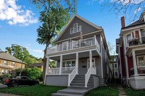 A two-story house with a balcony and a front porch. - Family-Friendly 6-bedroom house in Charming Buffalo with WiFi, AC (Buffalo)