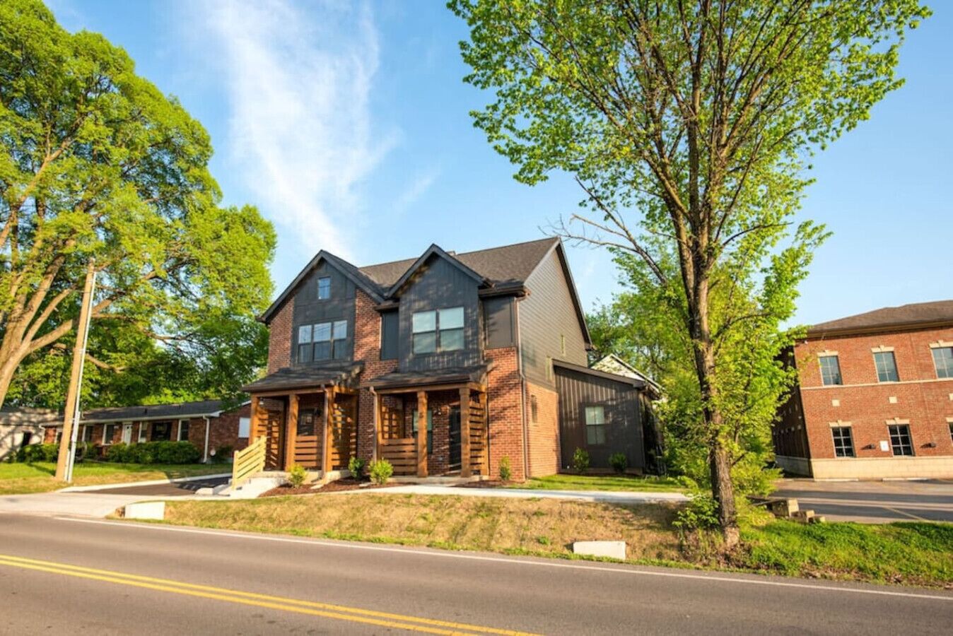 A two-story house with a front porch, a garage, and a driveway.