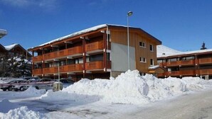 A multi-story wooden building with balconies, surrounded by snow. - 1st floor, tv, 52m², Alpe d'Huez (L'Alpe d'Huez)