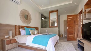 Un dormitorio moderno con una cama grande, cabecero de madera y un televisor sobre un mueble de madera.