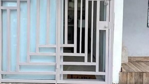 A white door with a glass panel and a metal gate. - Apt Private +WiFi+AC+Kitchen @Dominican Republic (Santiago Province)