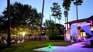 A backyard with a patio area, string lights, and outdoor furniture. - Bohemian Home•King Bed•Long Stay•RV/Boat/Trailer Parking•RenFest (Magnolia)