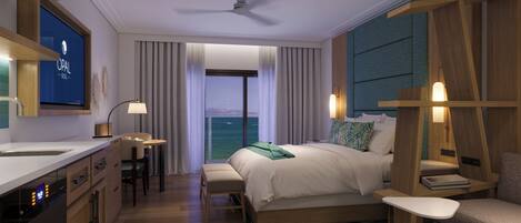 A modern hotel room with a large bed, a desk, a chair, and a view of the sea.