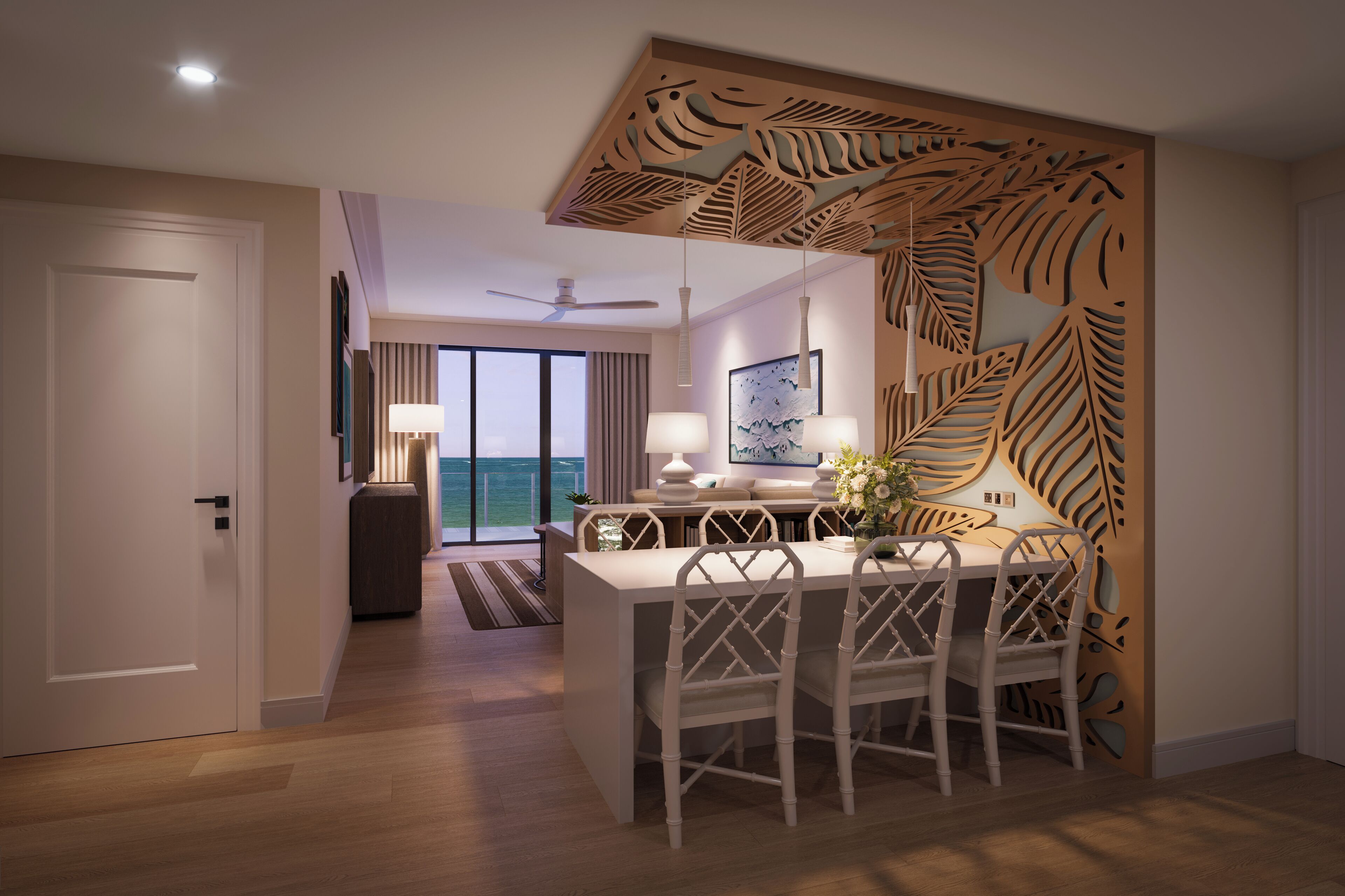 A modern hotel room with a dining area, a ceiling fan, and a view of the ocean.