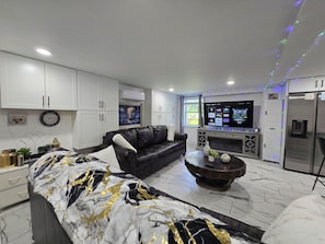 Business Apartment | Living area | 65-inch Smart TV with digital channels