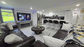 Business Apartment | Living area | 65-inch Smart TV with digital channels