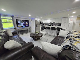 Business Apartment | Living area | 65-inch Smart TV with digital channels