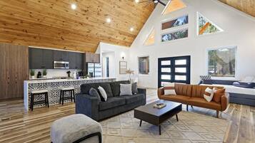 Cabin, Multiple Beds, Hot Tub, Garden View (Harvest Moon Lodge) | Living area | 65-inch flat-screen TV with digital channels, fireplace