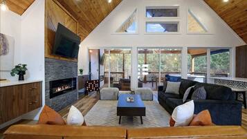 Cabin, Multiple Beds, Hot Tub, Garden View (Harvest Moon Lodge) | Living area | 65-inch flat-screen TV with digital channels, fireplace