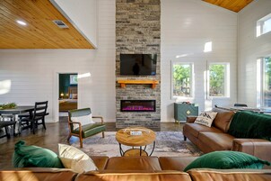 Cabin, Multiple Beds, Hot Tub, Garden View (Hidden Pearl) | Living area | 50-inch flat-screen TV with digital channels, fireplace