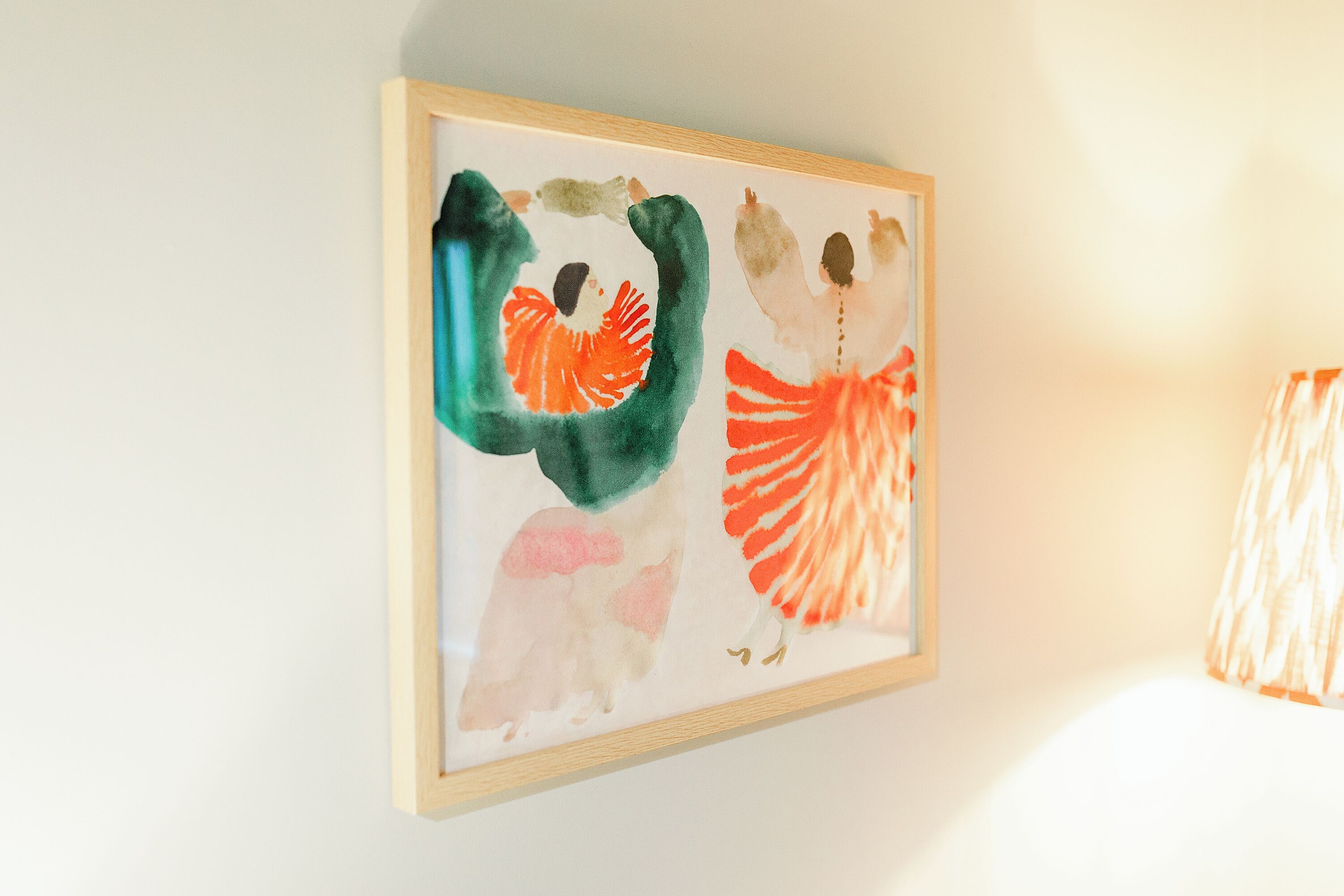 A framed abstract painting on a wall.