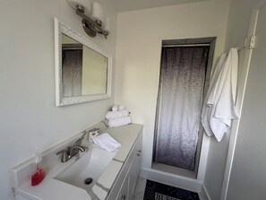 Een haardroger, handdoeken, zeep, toiletpapier