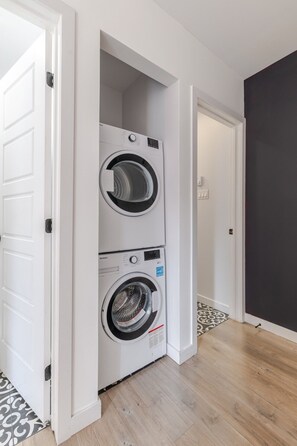 A laundry room with two stacked front-loading washing machines.