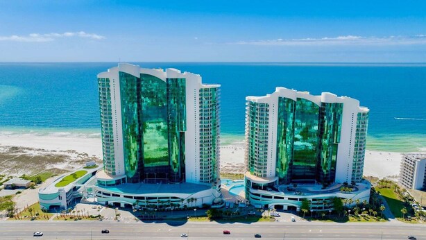 Two high-rise buildings with a beach and ocean in the background. - Turquoise Place D1008 | Gorgeous Updates! Oversized, hot tub/grill on deck, huge slide for kids! (Orange Beach)
