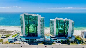 Two high-rise buildings with a beach and ocean in the background. - Turquoise Place D1008 | Gorgeous Updates! Oversized, hot tub/grill on deck, huge slide for kids! (Orange Beach)