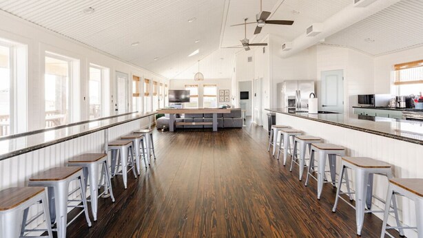 A spacious kitchen with a central island, bar stools, and a long counter. - 1 Block from the Beach, Entertainment Deck with games and Tv, large enough for 26 guests. (Bolivar Peninsula)