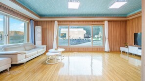 Enjoy a scenic view from the large window, relax on the comfortable sofa, and unwind with entertainment options.