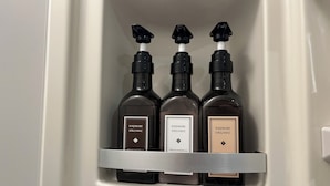 Three bottles of Hajimari Organic skincare products in a white cabinet. - KOREGA Hostel Osaka Namba - Hostel (Osaka)