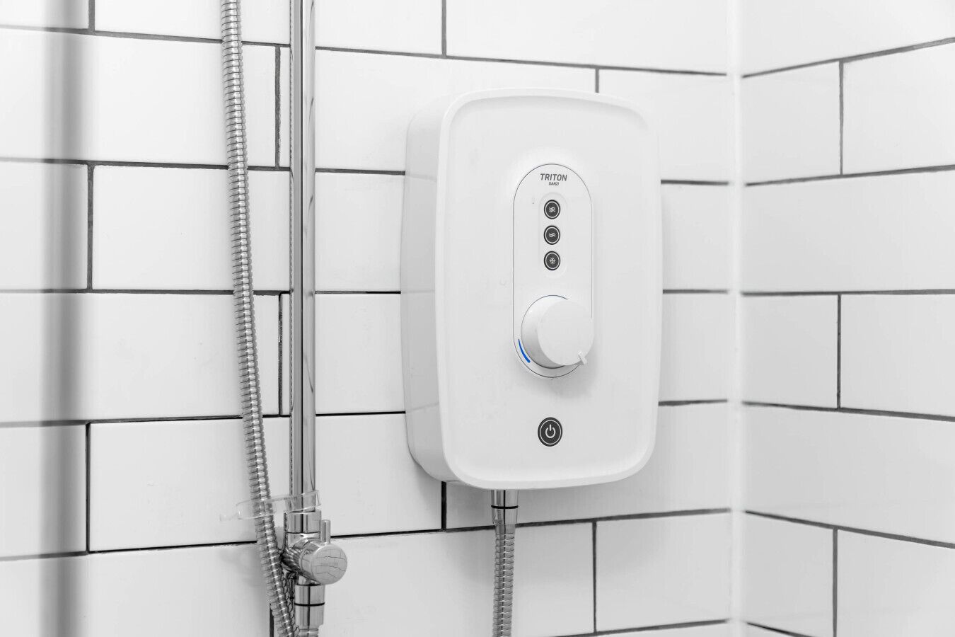 A white shower control panel with a power button, two temperature settings, and a water flow control knob.