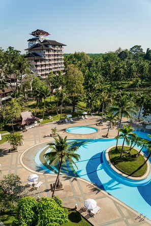 A resort with multiple swimming pools, palm trees, and a large building with a unique roof design. - Krabi Maritime Resort  (Krabi)