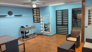 A room with a wooden floor, a desk with a chair, a white shelf, a mirror, and a window with blinds. - Comfortable & Beautiful house in Caucel (Merida)