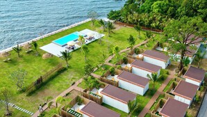 A coastal resort with multiple bungalow-style accommodations, a central pool, and lush greenery. - Charome Resort (Khlong Yai)