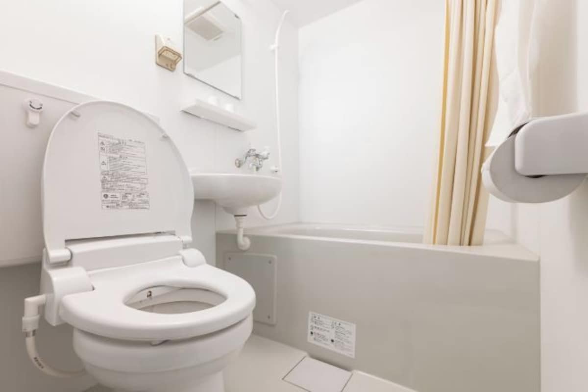 A modern bathroom with a white toilet, sink, and bathtub.