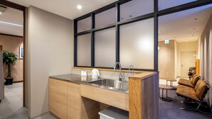 A modern kitchen with a built-in sink, wooden cabinets, and a countertop.