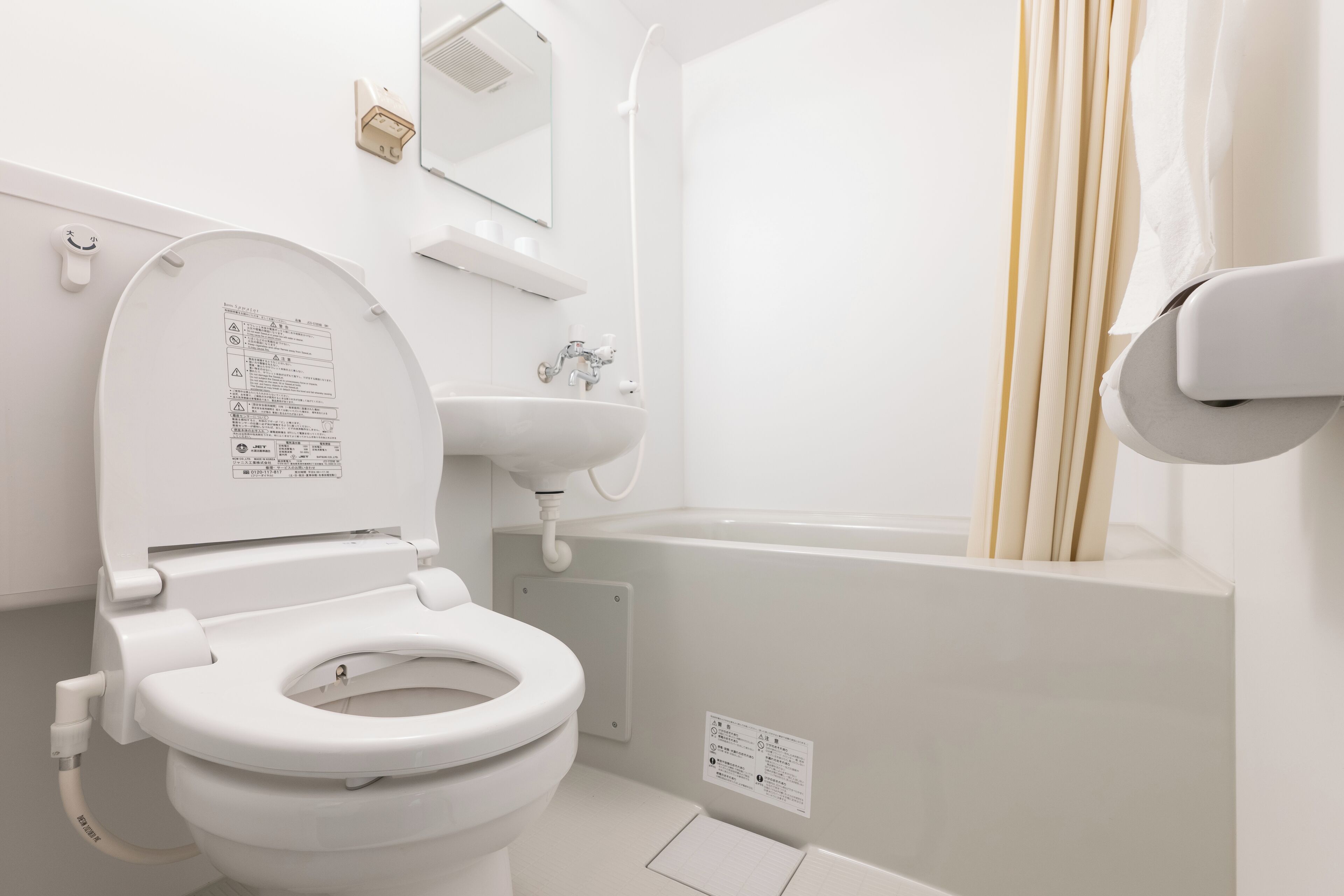 Combined shower/bathtub, hair dryer, slippers, towels