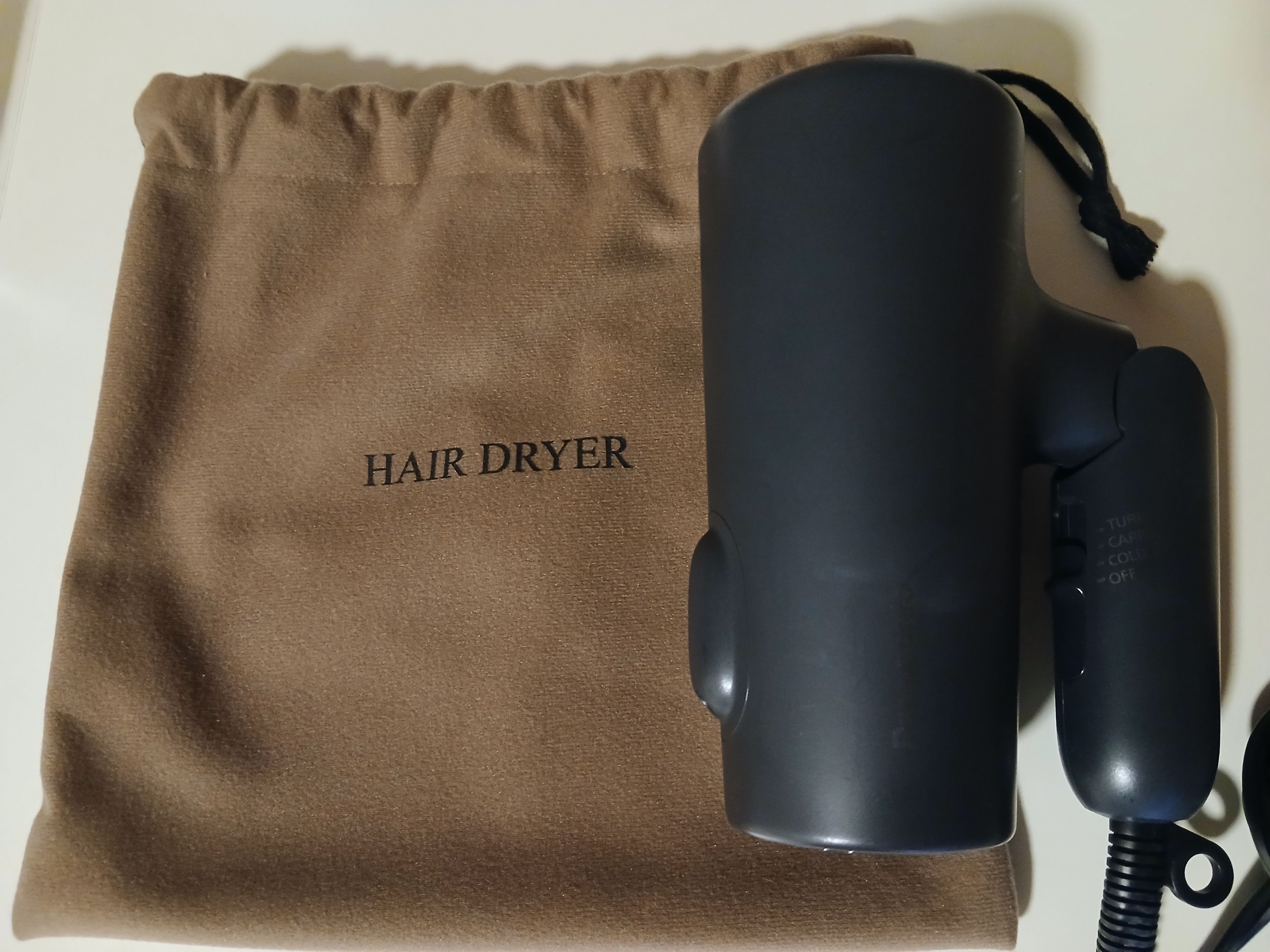 A hair dryer and its packaging.