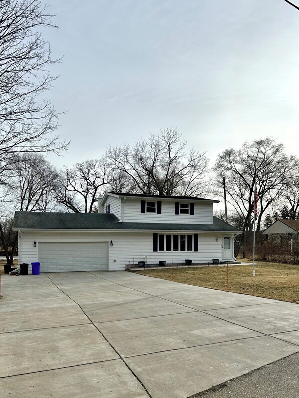A single-story house with a garage, a front porch, and a small front yard.
