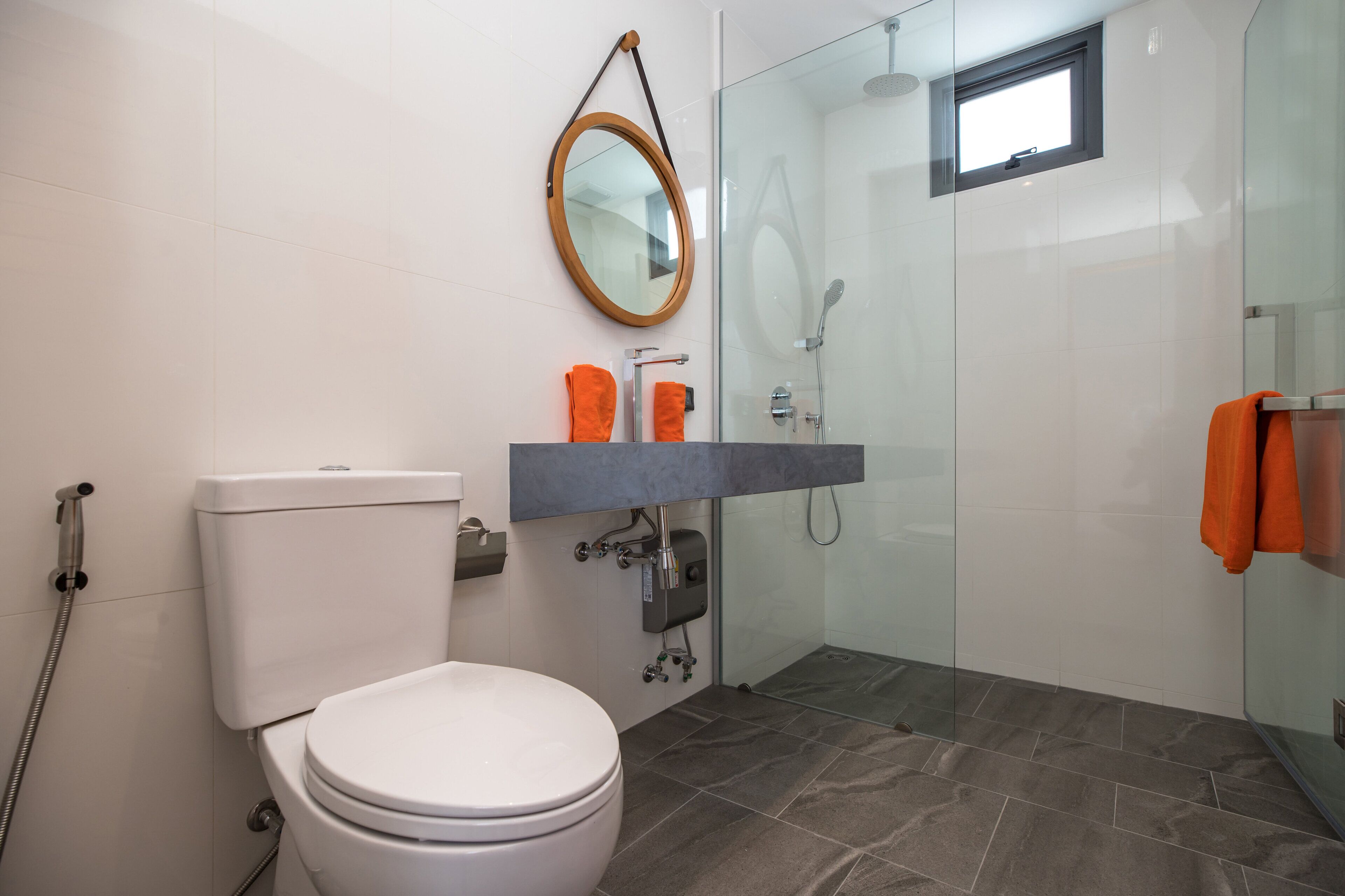 A bathroom with a toilet, a sink, and a shower.