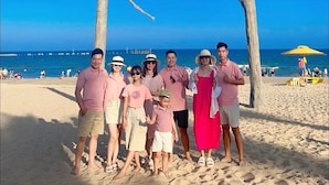 A group of people standing in front of a sign that reads "Nova World Phan Thiet". - Deluxe 3 Br Corner House - Novaworld PT (Tien Thanh)